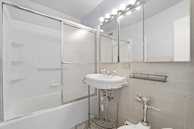 a bathroom with a sink a mirror and a shower