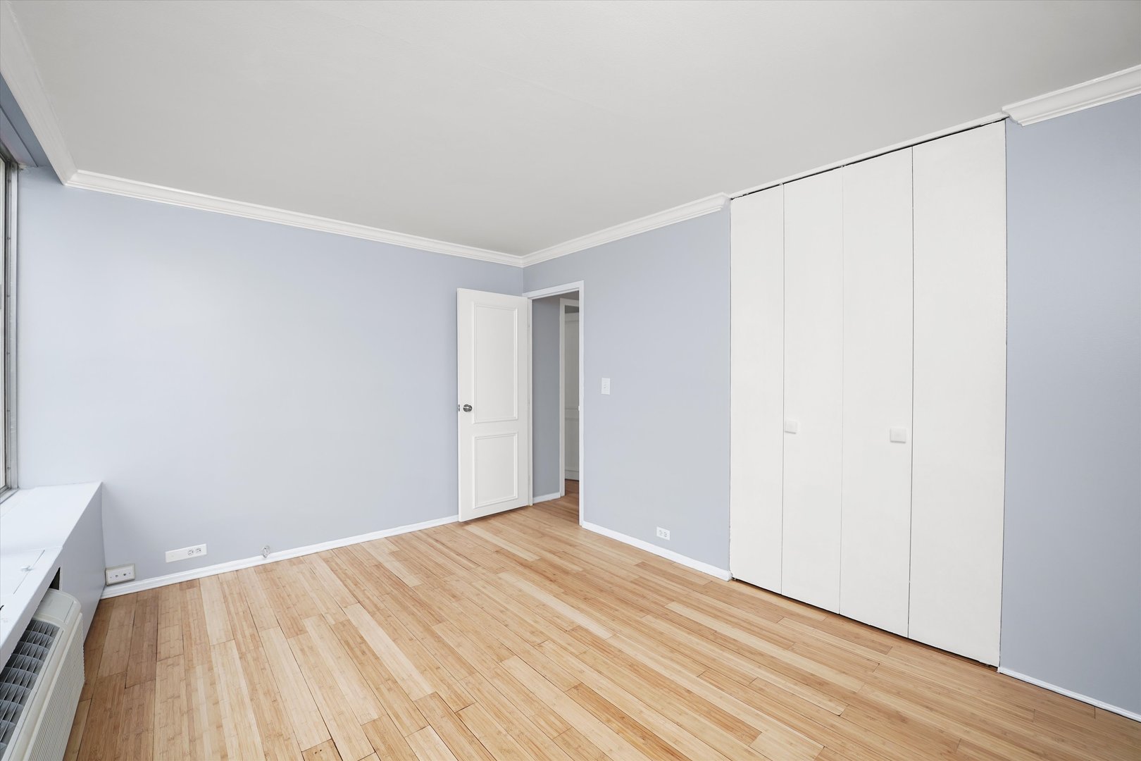 5757 North Sheridan Road, Unit 5J Chicago, IL 60660 - Photo 22 of 44 a view of an empty room with wooden floor