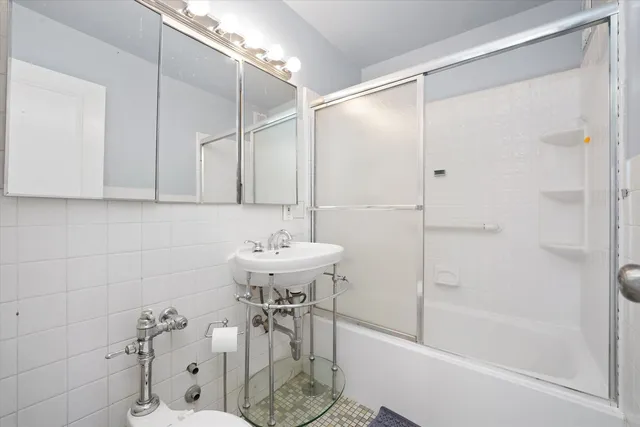 a bathroom with a shower and a sink