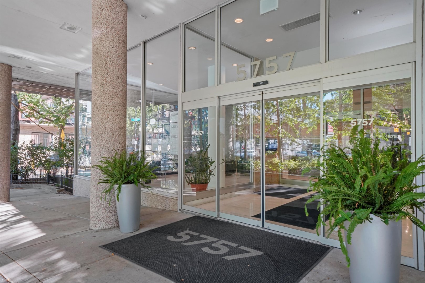 5757 North Sheridan Road, Unit 5J Chicago, IL 60660 - Photo 24 of 44 a living room with glass windows and flower plants