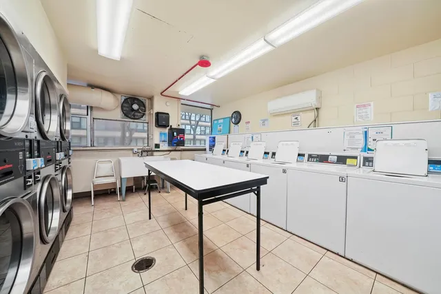 a kitchen with stainless steel appliances kitchen island granite countertop a sink and cabinets