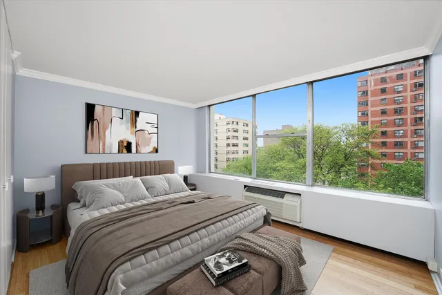 a bedroom with a large bed and a window