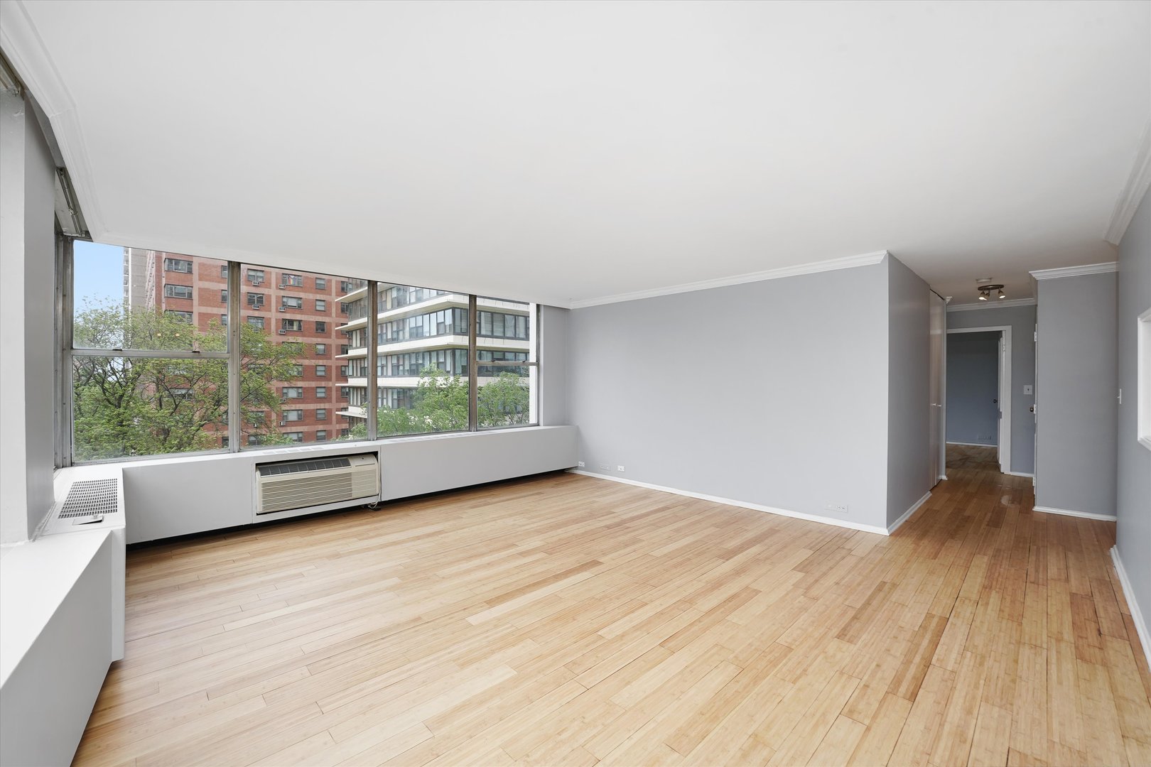 5757 North Sheridan Road, Unit 5J Chicago, IL 60660 - Photo 10 of 44 wooden floor in an empty room with a window