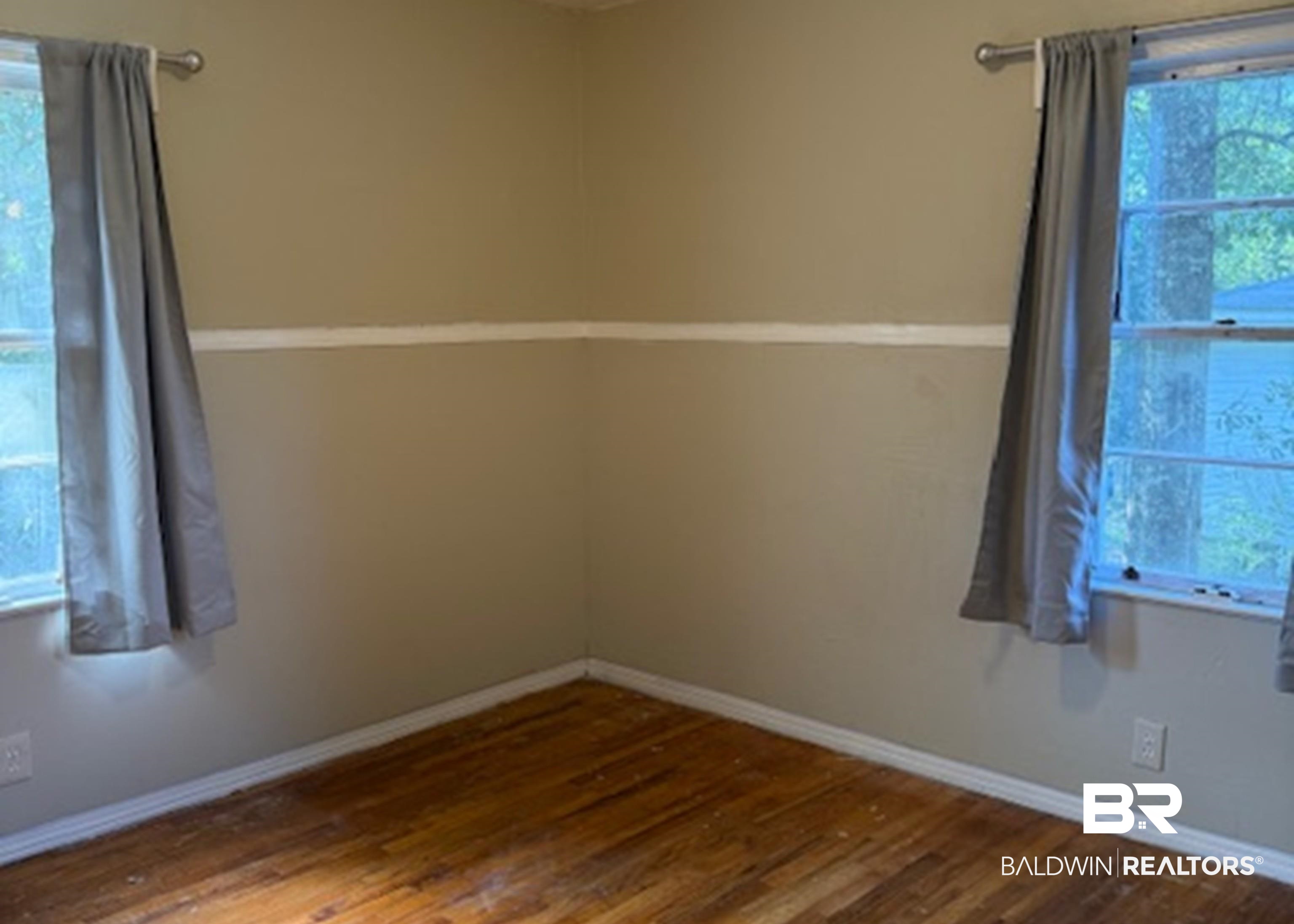 1809 Harris Road Mobile, AL 36618 - Photo 8 of 11 Unfurnished room with dark wood finished floors and baseboards