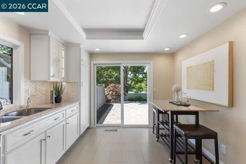a kitchen with sink table and chairs