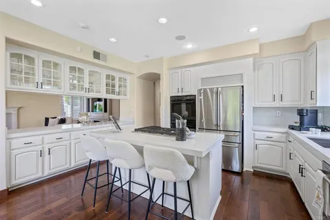 a kitchen with a stove a sink a microwave and cabinets