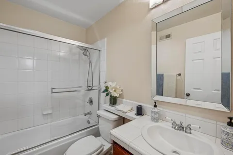 a spacious bedroom with furniture and a fireplace