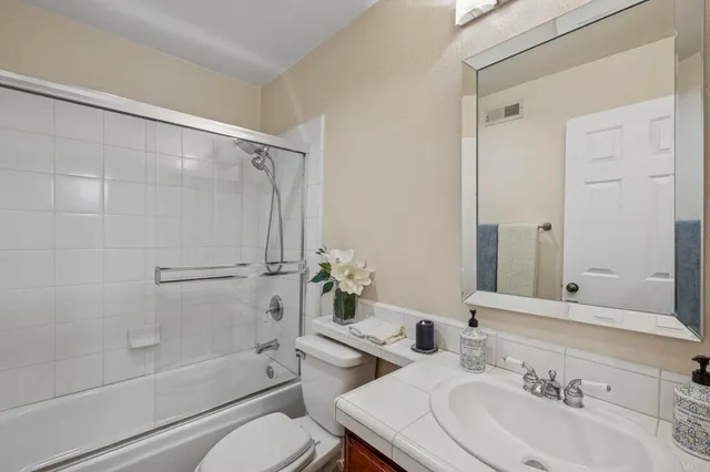 a spacious bedroom with furniture and a fireplace