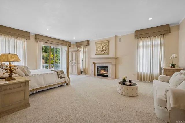 a white bed sitting in a room next to a window