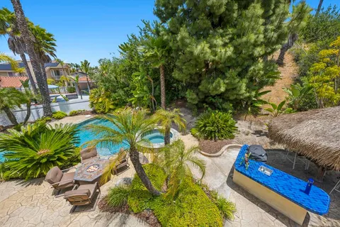 an aerial view of residential houses with outdoor space and street view