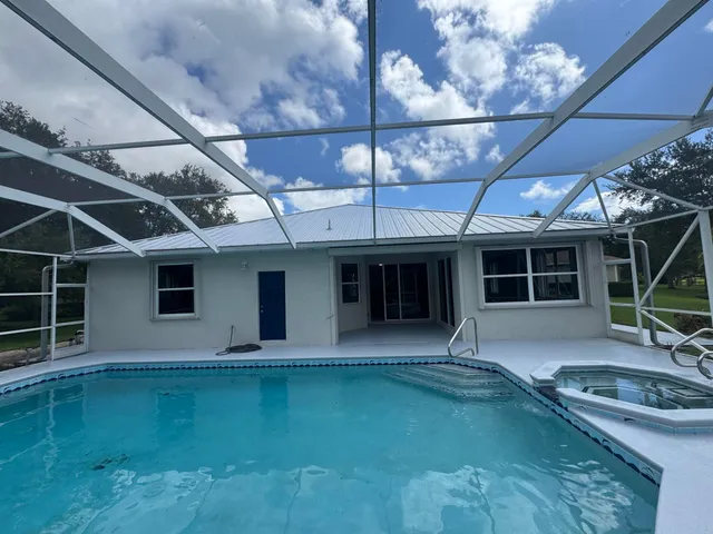 a view of a house with a yard in front of it