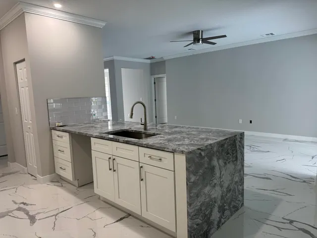 a kitchen with a sink and cabinets