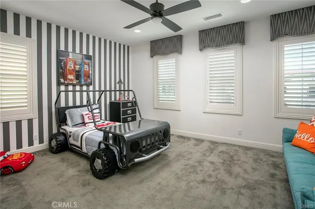 a bedroom with bed and a window