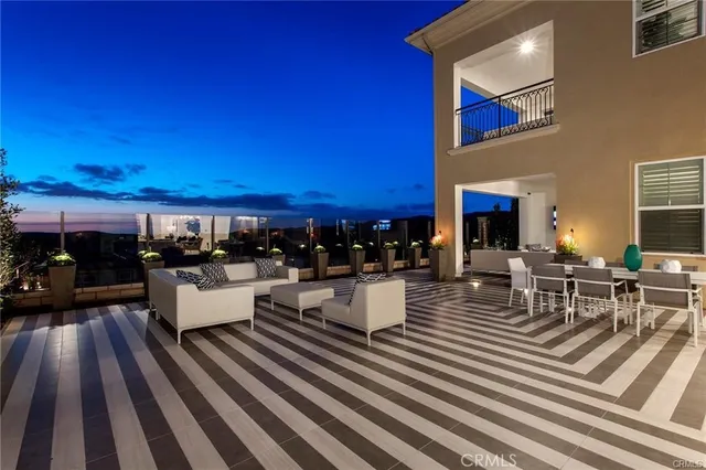 a view of a patio with dining table and chairs with wooden floor and fence