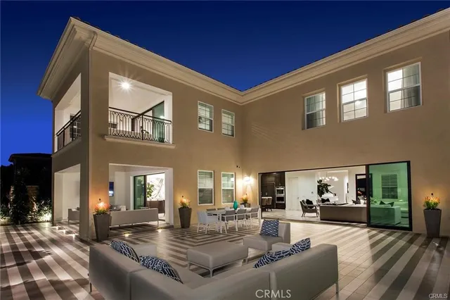 a view of a house with couches chairs and a table
