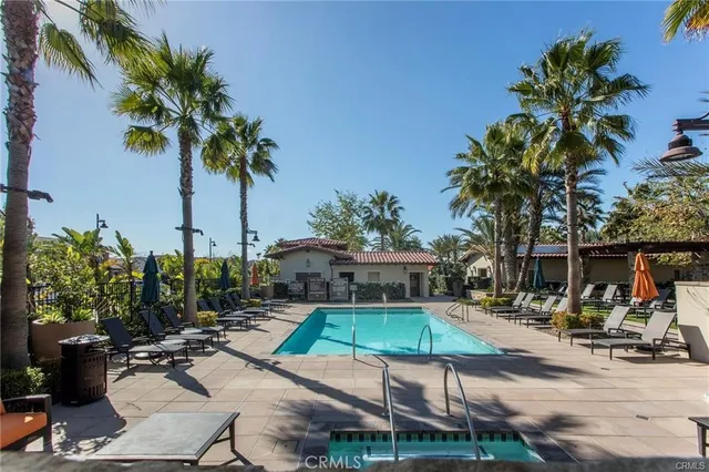 a view of a backyard with a patio and swimming pool