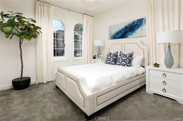 a bedroom with a bed and a potted plant