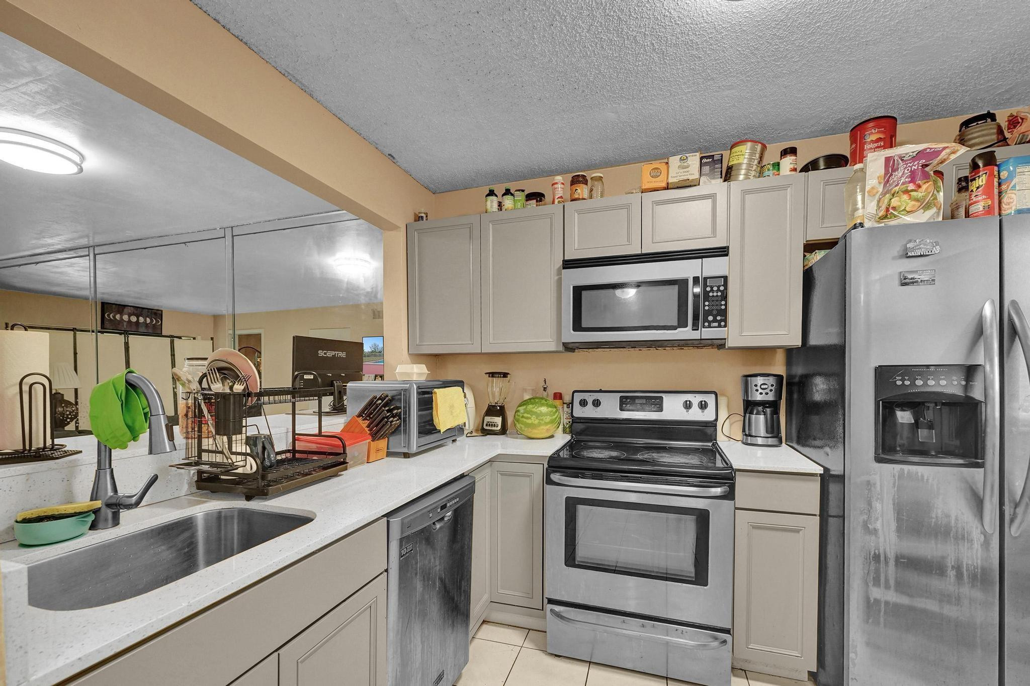 a kitchen with stainless steel appliances a stove a sink and a microwave