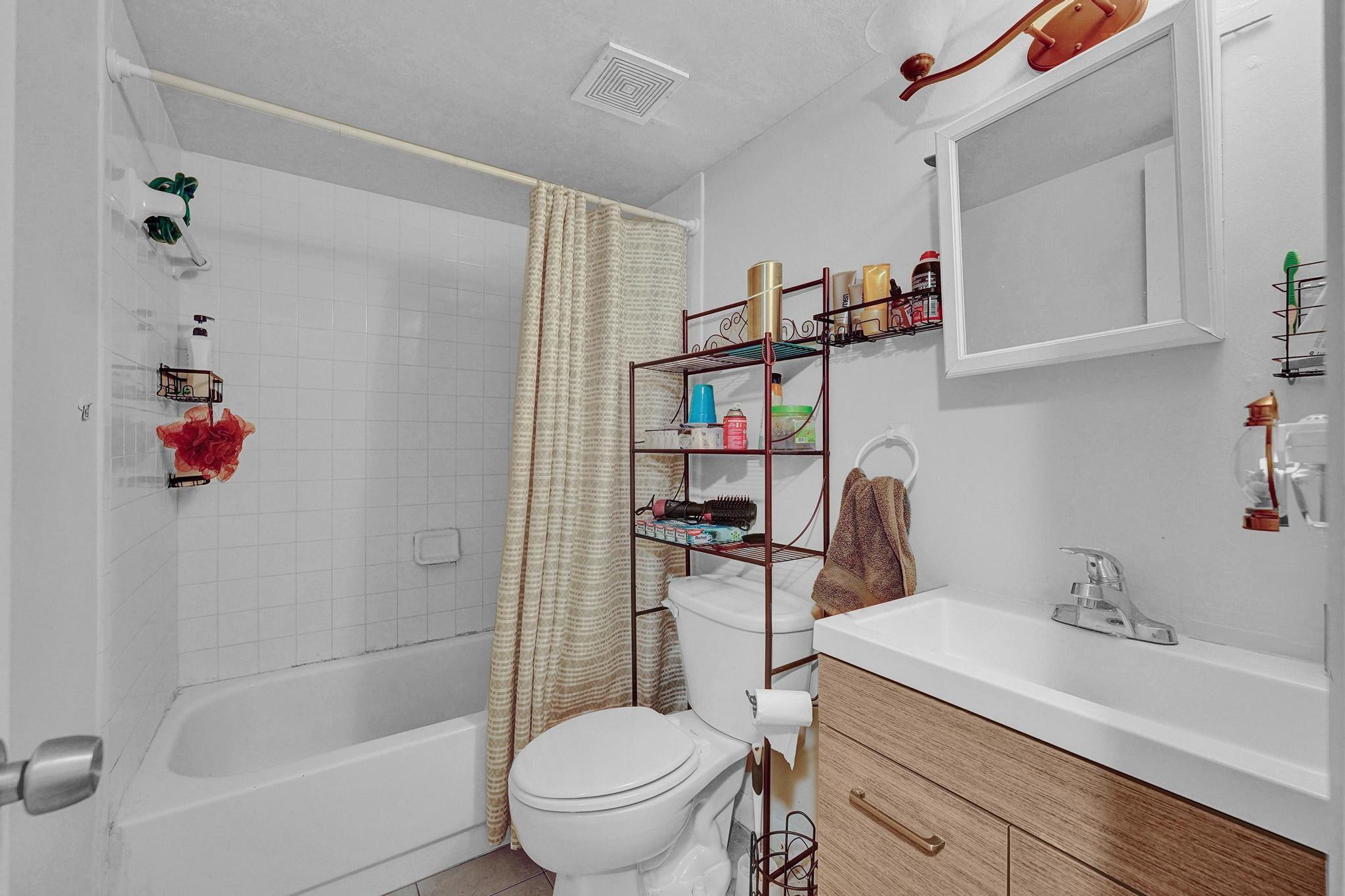 3396 Foxcroft Road, Unit 106 Miramar, FL 33025 - Photo 11 of 24 a bathroom with a sink toilet and shower