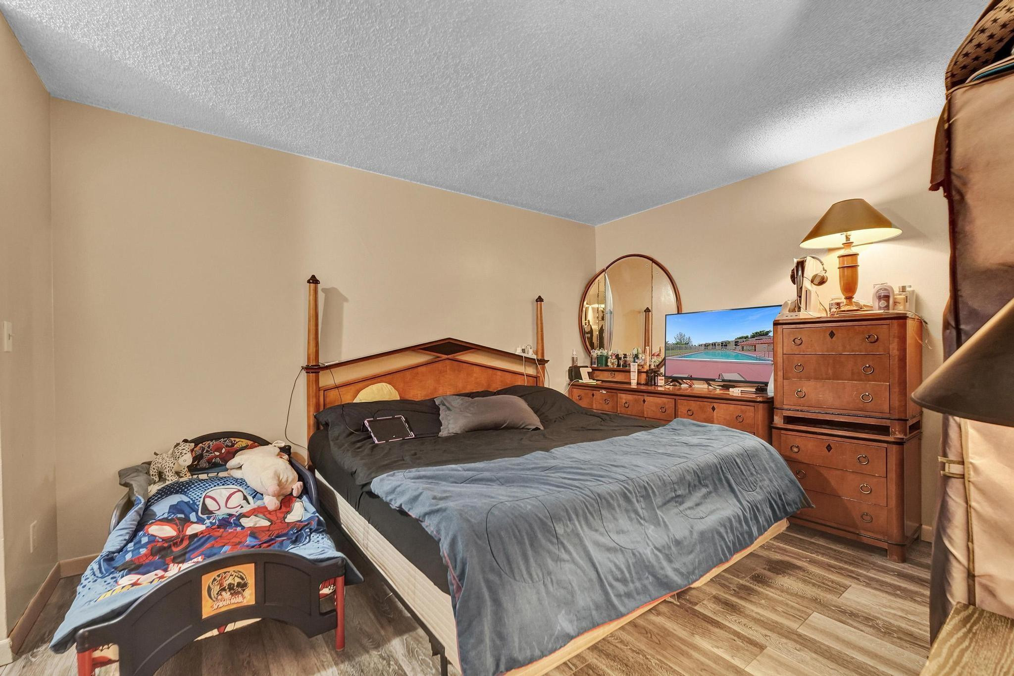 3396 Foxcroft Road, Unit 106 Miramar, FL 33025 - Photo 14 of 24 a bedroom with a bed and a view of bedroom