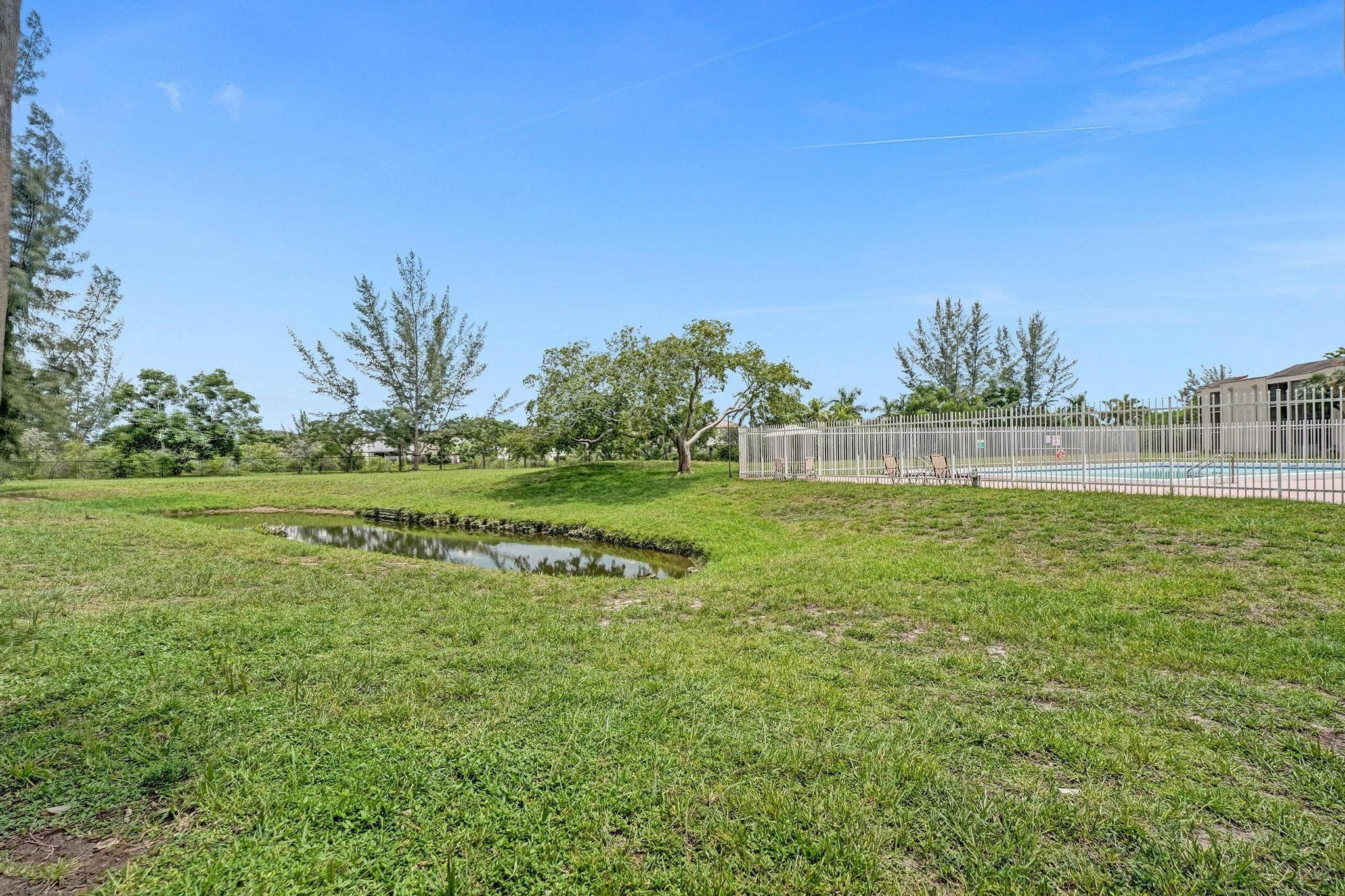 3396 Foxcroft Road, Unit 106 Miramar, FL 33025 - Photo 18 of 24 a view of a garden with a building in the background
