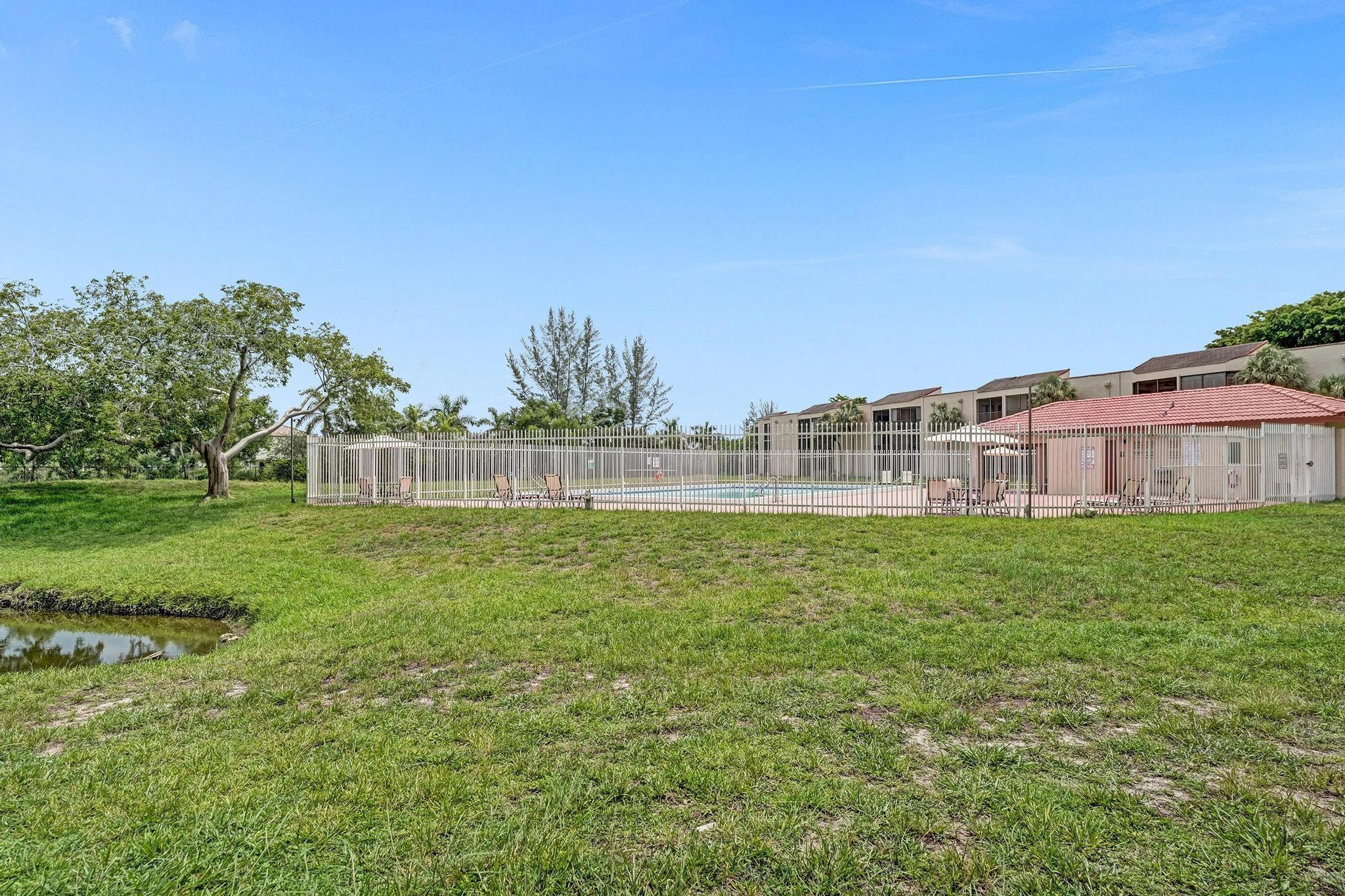 3396 Foxcroft Road, Unit 106 Miramar, FL 33025 - Photo 19 of 24 a view of a green field with house in the background
