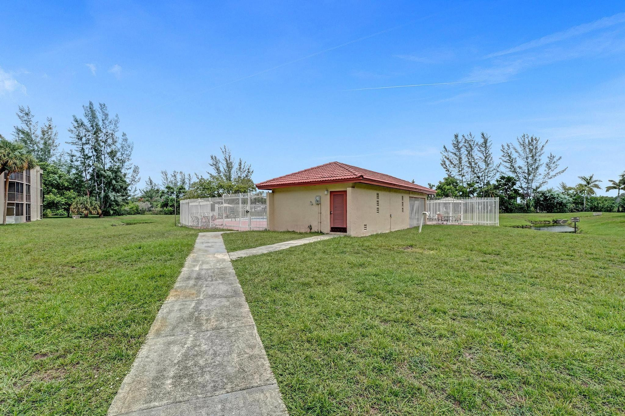 3396 Foxcroft Road, Unit 106 Miramar, FL 33025 - Photo 20 of 24 a front view of a house with yard