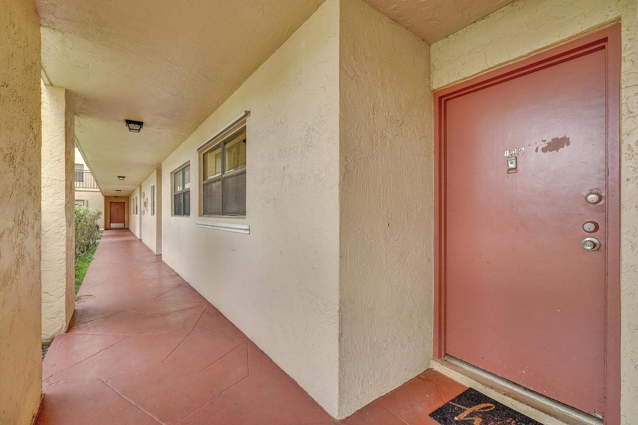 3396 Foxcroft Road, Unit 106 Miramar, FL 33025 - Photo 2 of 24 a view of a hallway with wooden floor and staircase