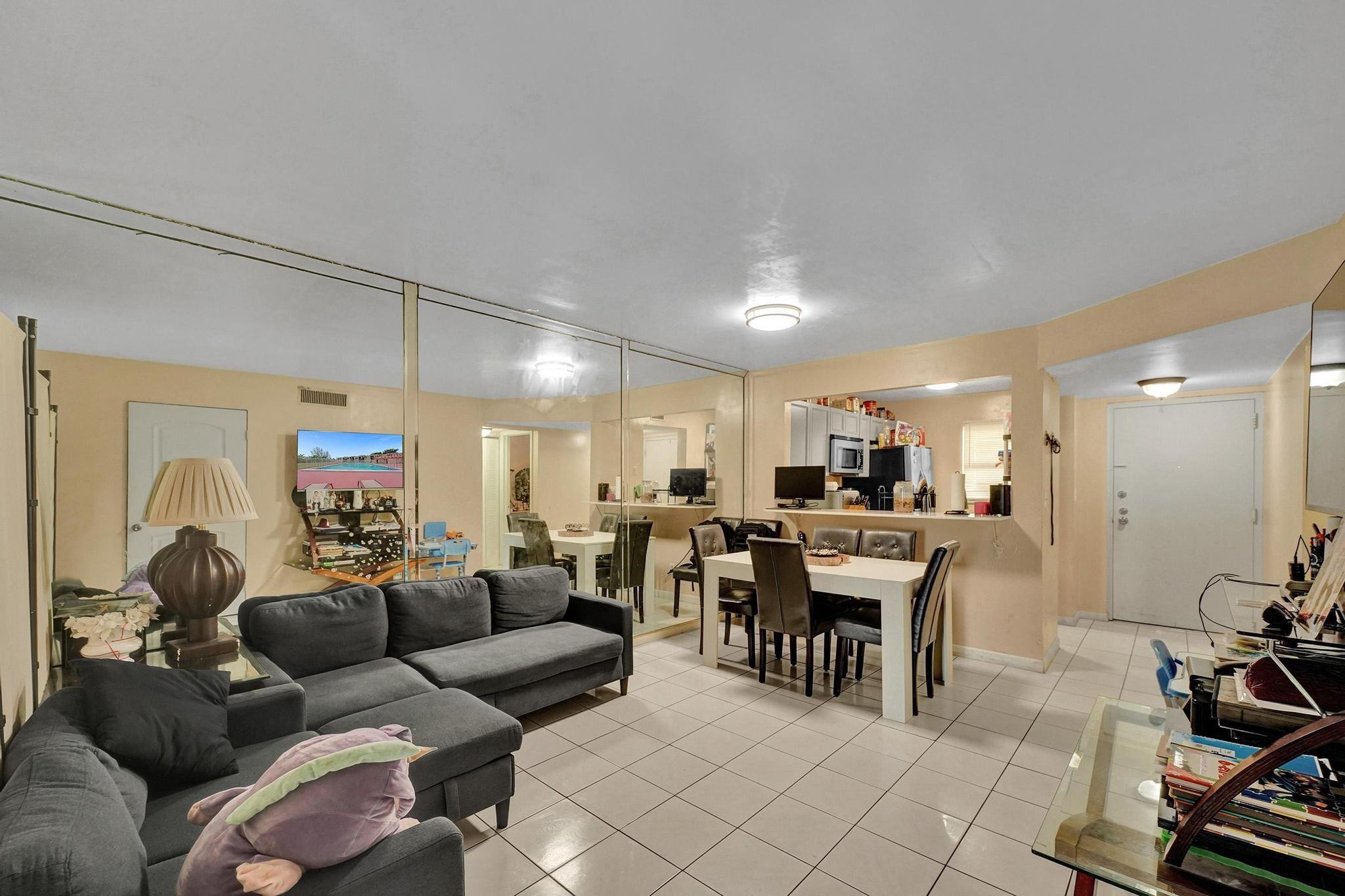 3396 Foxcroft Road, Unit 106 Miramar, FL 33025 - Photo 5 of 24 a living room with furniture and a large window