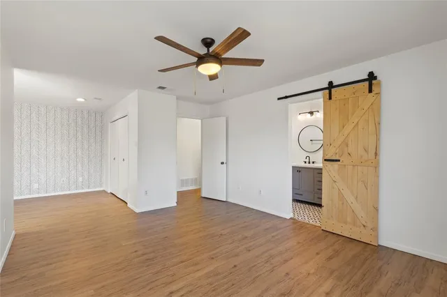 a view of an empty room and wooden floor