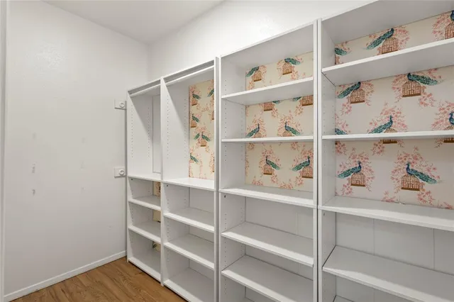 a view of a bedroom with shelf on the wall