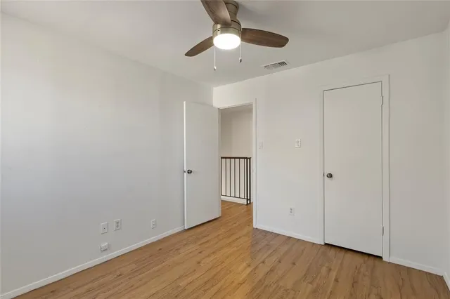 a view of an empty room and wooden floor