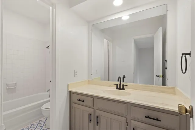a bathroom with a sink a toilet and a bathtub