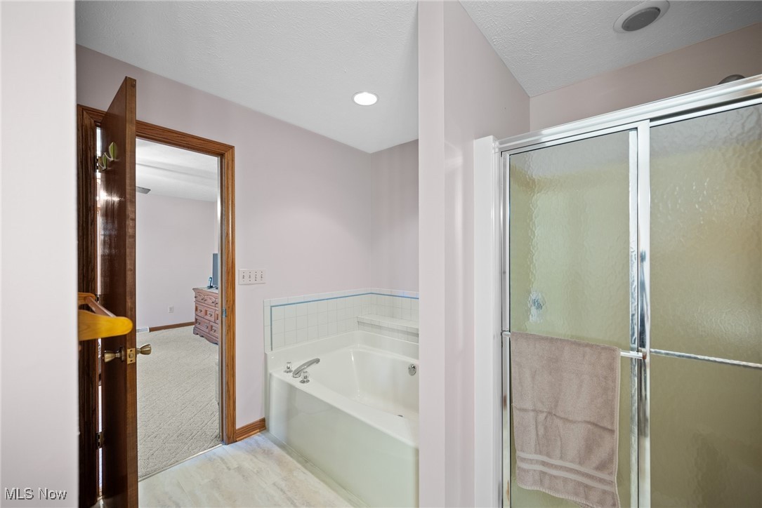 3190 Hamilton Road Medina, OH 44256 - Photo 10 of 37 Bathroom with independent shower and bath and a textured ceiling