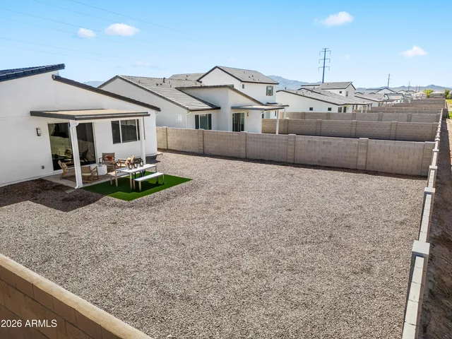 a view of a house with backyard and sitting area