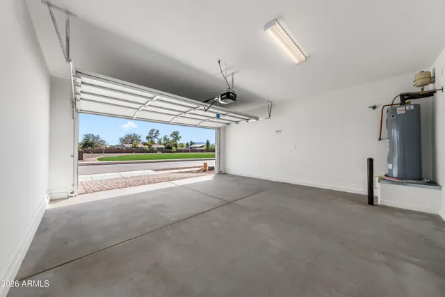 a view of an empty room with a fireplace and wooden floor
