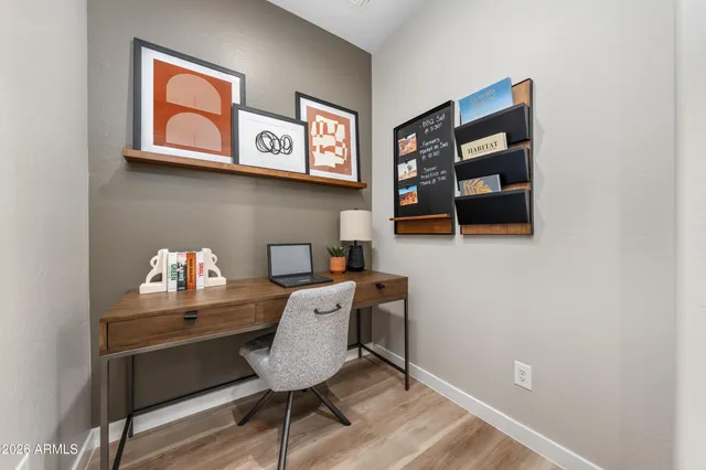 a kitchen with stainless steel appliances granite countertop a refrigerator a stove a sink a dining table and chairs