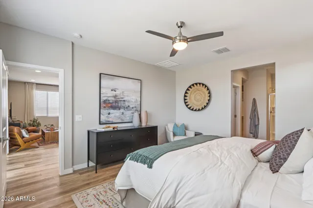 a bedroom with a bed and a chandelier