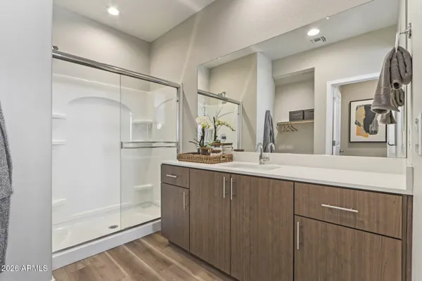 a bedroom with bed and a chandelier