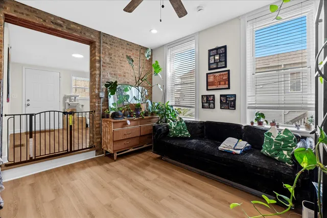 a living room with furniture and flowers
