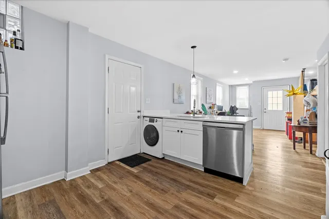 a view of a kitchen with wooden floor