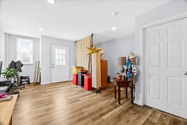 a view of a livingroom with furniture gym equipment and windows