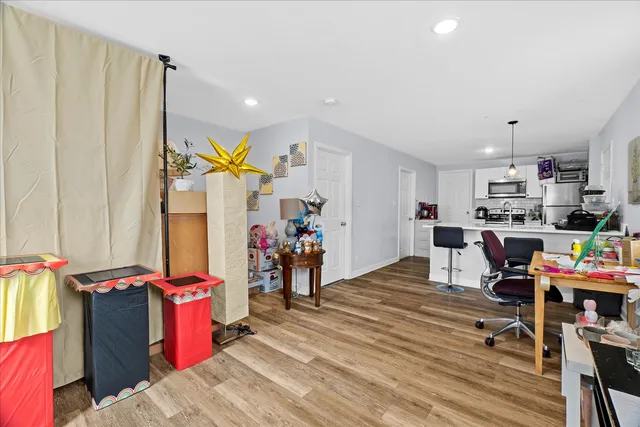 a living room filled with furniture and a wooden floor