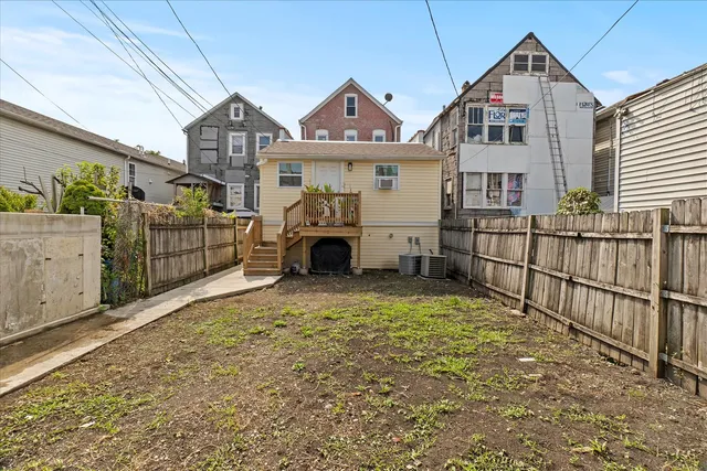 a view of a house with wooden fence