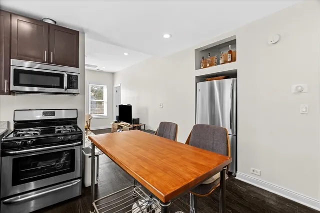 a kitchen with stainless steel appliances a stove microwave and refrigerator