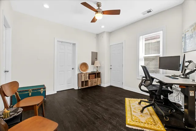 a view of a workspace with furniture and a window