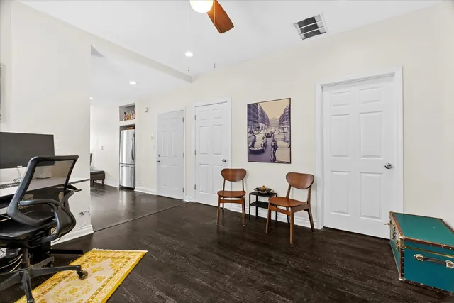 a view of a workspace with furniture and wooden floor