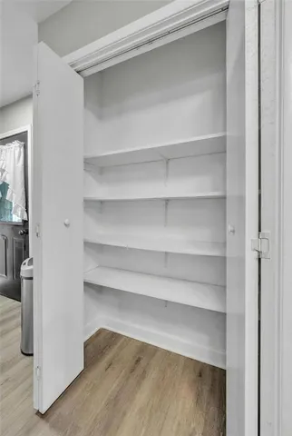 a view of walk in closet with empty racks