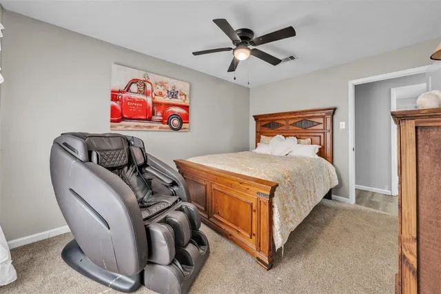 a bedroom with furniture and ceiling fan