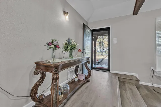 a view of an entryway with wooden floor